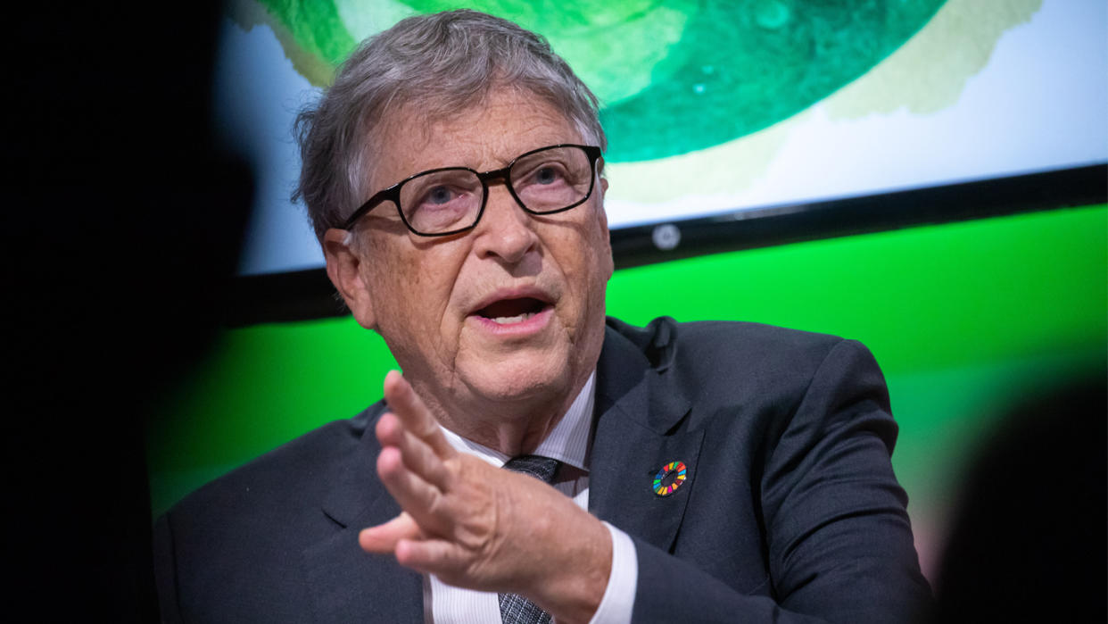 Bill Gates makes an emphatic point against a green background.