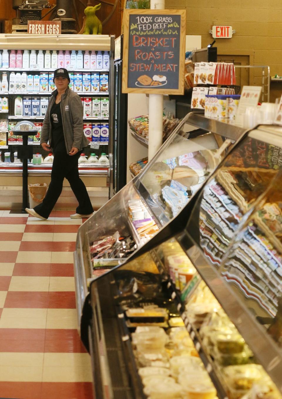 Stephanie Sturtz, an employee at Seven Grains Natural Market in Tallmadge,  heads to the produce area.