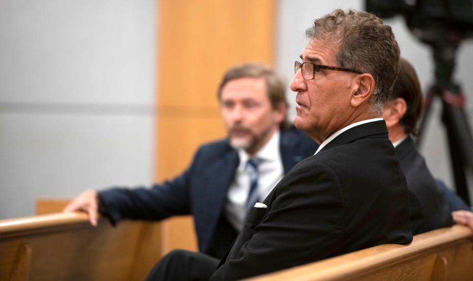 Pensacola dentist Charles Stamitoles waits in the courtroom with his legal team as they prepare for the jury selection process to begin on Monday.