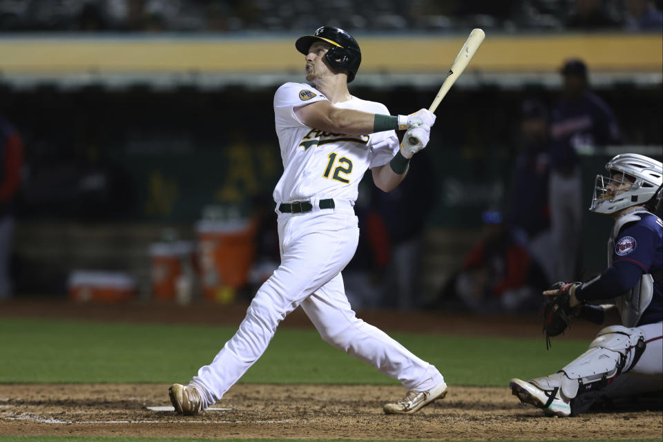 Oakland Athletics' Sean Murphy watches his two-run single in front of Minnesota Twins catcher Ryan Jeffers during the seventh inning of a baseball game in Oakland, Calif., Tuesday, May 17, 2022. (AP Photo/Jed Jacobsohn)