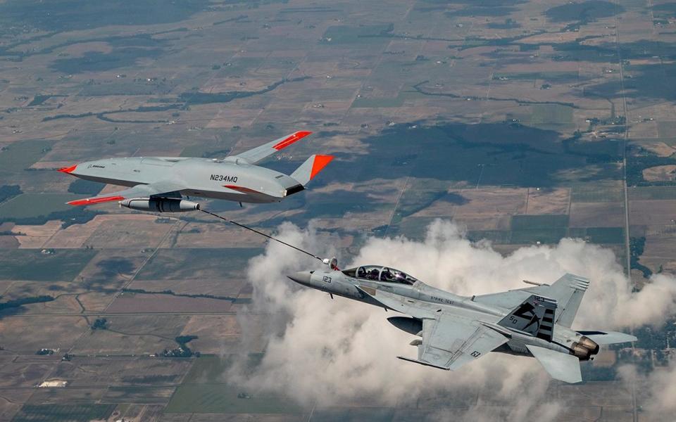 An MQ-25 Stingray unmanned drone refuels a manned US Navy F/A-18 fighter in a history-making 2021 test. The MQ-25 could easily carry out other roles, if the Navy wants it to