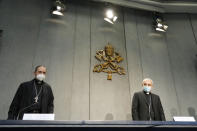 Mons. Filippo Iannone, right, and Mons. Juan Ignacio Arrieta Ochoa de Chinchetru arrive for a press conference to illustrate changes in the Church's Canon law, at the Vatican, Tuesday, June 1, 2021. Pope Francis has changed church law to explicitly criminalize the sexual abuse of adults by priests who abuse their authority and to say that laypeople who hold church office can be sanctioned for similar sex crimes. (AP Photo/Andrew Medichini)