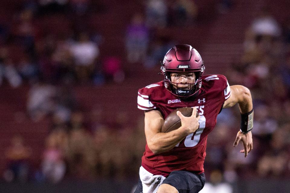 Aggie quarterback Diego Pavia runs the ball during a NMSU football game on Wednesday, Oct. 11, 2023, at the Aggies Memorial Stadium.