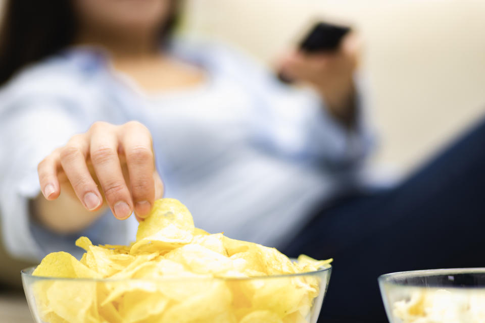 Concept take potato chips with you to watch movie. Close up. Blurred background.