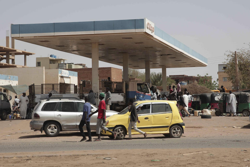 People line up at a gasoline station in Khartoum, Sudan, Saturday, April 29, 2023, as gunfire and heavy artillery fire continued despite the extension of a cease-fire between the country's two top generals. The battle for power between the country's army and its rival paramilitary has killed hundreds and sent thousands fleeing for their lives. (AP Photo/Marwan Ali)