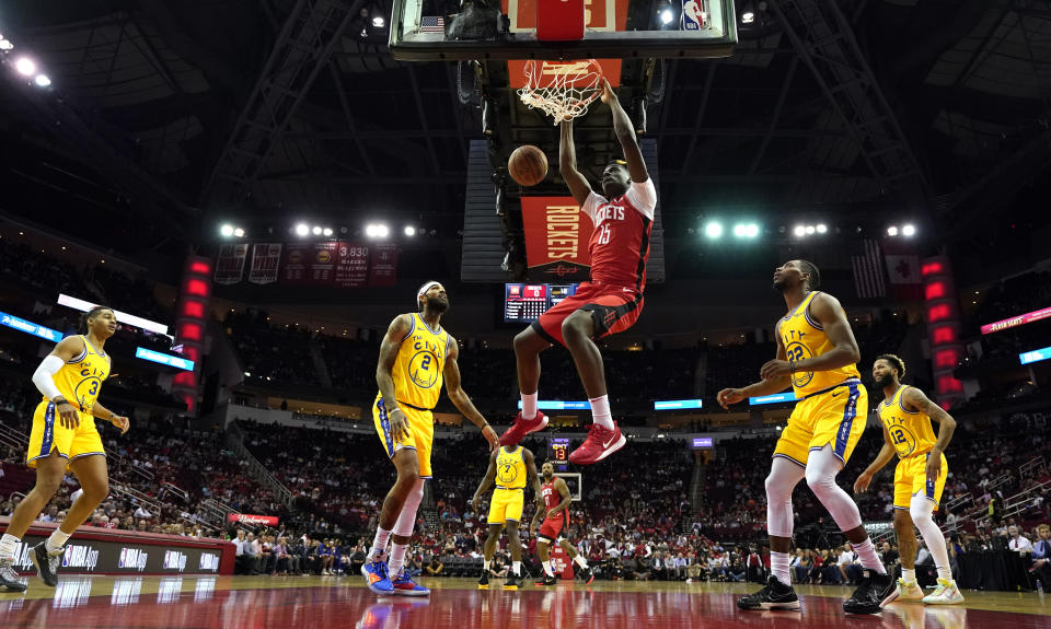 Houston Rockets' Clint Capela (15) dunks the ball as Golden State Warriors' Jordan Poole (3), Willie Cauley-Stein (2), Glenn Robinson III (22) and Ky Bowman (12) watch during the first half of an NBA basketball game Wednesday, Nov. 6, 2019, in Houston. (AP Photo/David J. Phillip)