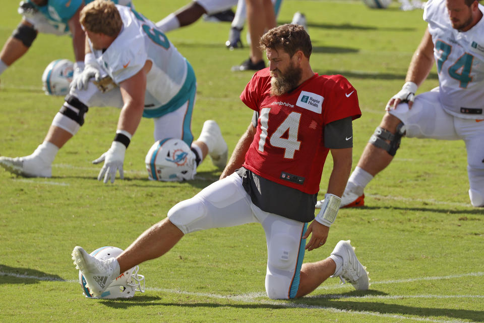 Miami Dolphins quarterback Ryan Fitzpatrick (14) stretches prior to an NFL football training camp practice in Davie, Fla., Tuesday, Sept. 1, 2020. (AP Photo/Joel Auerbach)