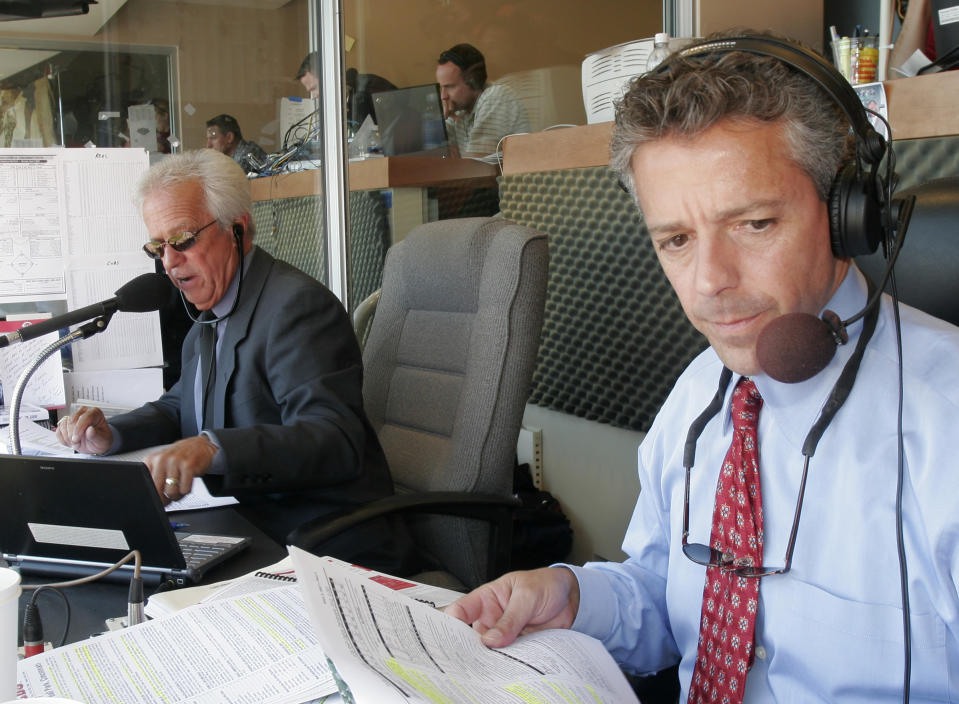 After Reds announcer Thom Brennaman uttered a gay slur on air Wednesday, both he and his father — former announcer Marty Brennaman, left — insisted that it didn't reflect who he is. (AP Photo/David Kohl)