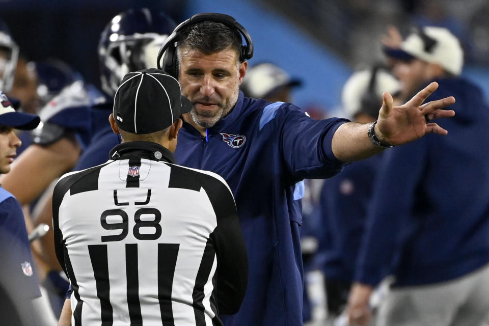 Tennessee Titans head coach Mike Vrabel speakls with line judge Greg Bradley (98) during the first half of an NFL football game against the Dallas Cowboys, Thursday, Dec. 29, 2022, in Nashville, Tenn. (AP Photo/Mark Zaleski)