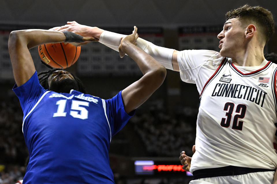 UConn center Donovan Clingan (32) blocks a shot by Seton Hall center Jaden Bediako (15) in the first half of an NCAA college basketball game, Sunday, March 3, 2024, in Storrs, Conn. (AP Photo/Jessica Hill)