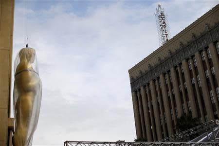 An Oscar statue is covered with plastic during preparations for the 86th Academy Awards in Hollywood, California February 26, 2014. REUTERS/Mario Anzuoni