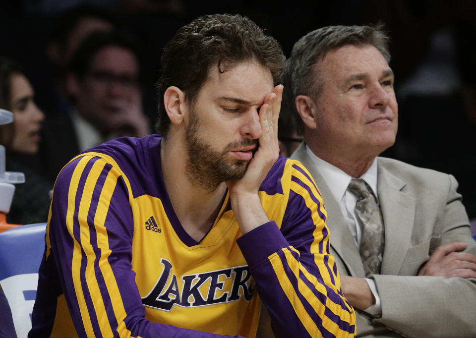 Los Angeles Lakers' Pau Gasol, of Spain, covers his face while sitting on the bench during the second half of an NBA basketball game against the Los Angeles Clippers on Thursday, March 6, 2014, in Los Angeles. The Clippers won 142-94. (AP Photo/Jae C. Hong)