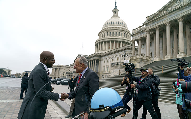 Sen. Raphael Warnock (D-Ga.) greets Majority Leader Charles Schumer (D-N.Y.)