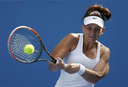 Casey Dellacqua of Australia hits a return to Kirsten Flipkens of Belgium during their women's singles match at the Australian Open 2014 tennis tournament in Melbourne January 15, 2014. REUTERS/Bobby Yip