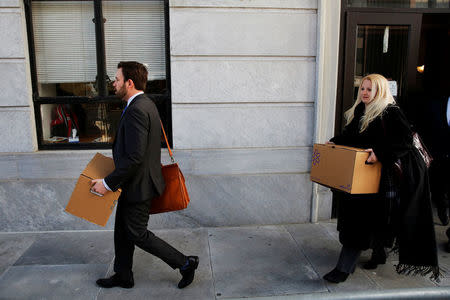 Members of the defense team for actor and comedian Bill Cosby carry boxes after a pre-trial hearing at the Montgomery County Courthouse in Norristown, Pennsylvania, U.S. March 6, 2018. REUTERS/Dominick Reuter