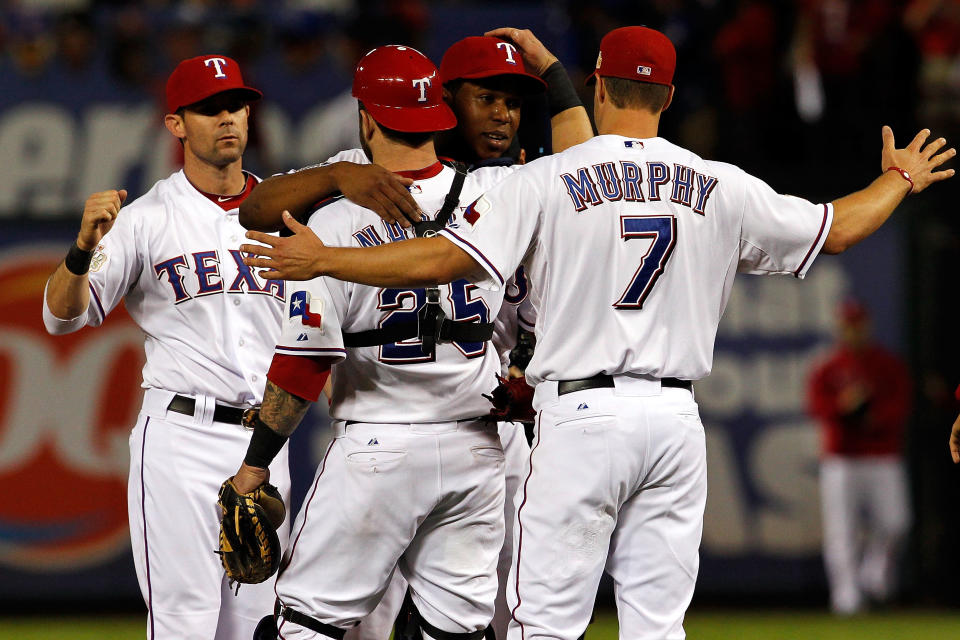 ARLINGTON, TX - OCTOBER 24: David Murphy #7, Mike Napoli #25, Neftali Feliz #30 and Michael Young #10 of the Texas Rangers celebrate after defeating the St. Louis Cardinals 4-2 during Game Five of the MLB World Series at Rangers Ballpark in Arlington on October 24, 2011 in Arlington, Texas. (Photo by Tom Pennington/Getty Images)