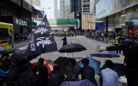 Protesters created barricades using umbrellas - Credit: AP Photo/Vincent Yu