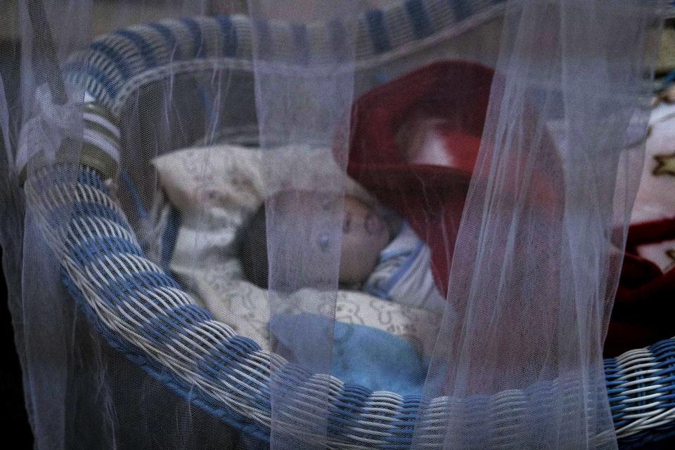 In this Aug. 19, 2018 file photo, a newborn lies in her crib at the state-run al-Zuhour orphanage, in Mosul, Iraq. At al-Zuhour it's a mix of infants born to Iraqi women who were enslaved by militants and older children whose parents are jailed; some were simply abandoned in the chaos that follows a war. (AP Photo/Maya Alleruzzo, File)