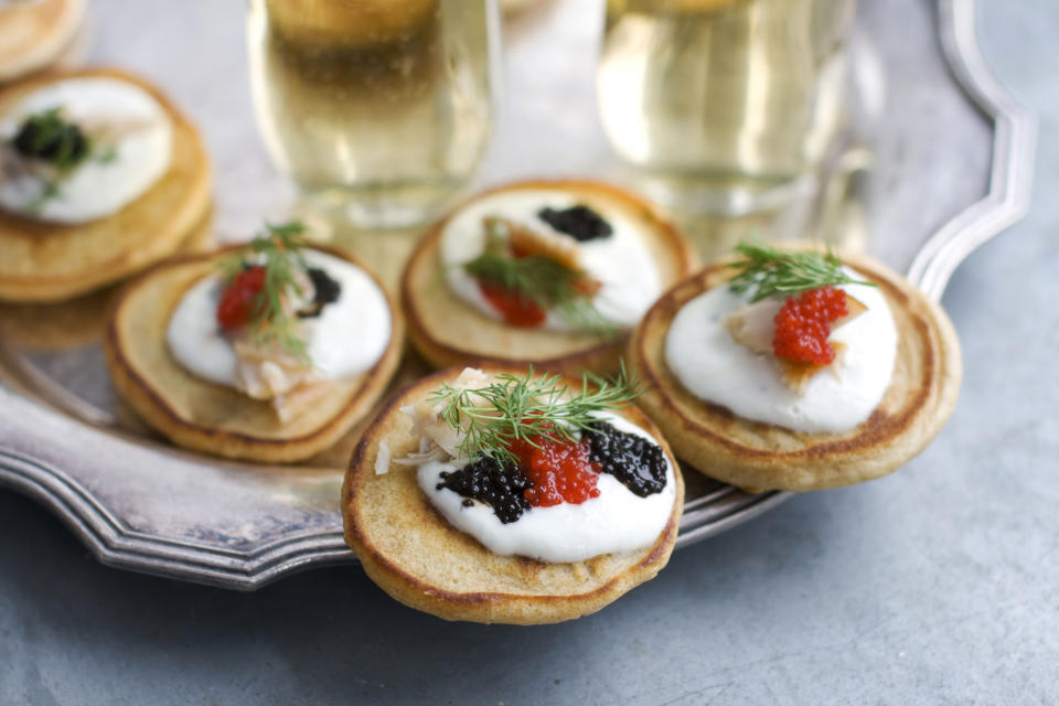 This Jan. 28, 2013 photo shows blini with smoked trout, caviar and horseradish cream served on a platter in Concord, N.H. These elegant hors d'oeuvres are perfect for an Oscar night viewing party. (AP Photo/Matthew Mead)