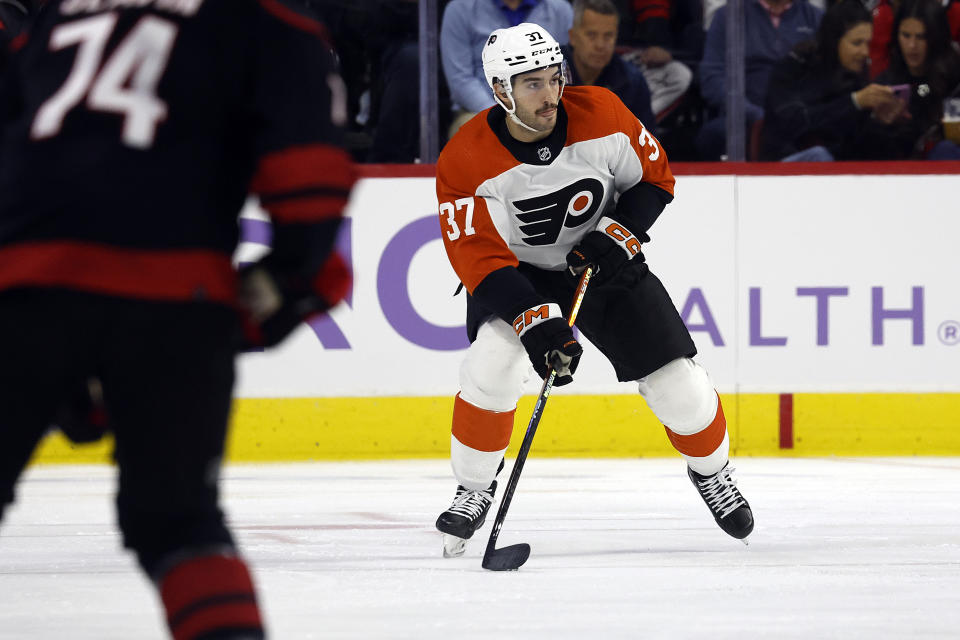 Philadelphia Flyers' Louie Belpedio (37) moves the puck up the ice against the Carolina Hurricanes during the first period of an NHL hockey game in Raleigh, N.C., Wednesday, Nov. 15, 2023. (AP Photo/Karl B DeBlaker)