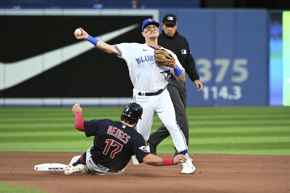 Toronto Blue Jays third baseman Matt Chapman throws to first base, too late to complete a double play on Cleveland Guardians' Will Benson after forcing out Austin Hedges (11) at second base during the fourth inning of a baseball game Friday, Aug. 12, 2022, in Toronto. (Jon Blacker/The Canadian Press via AP)