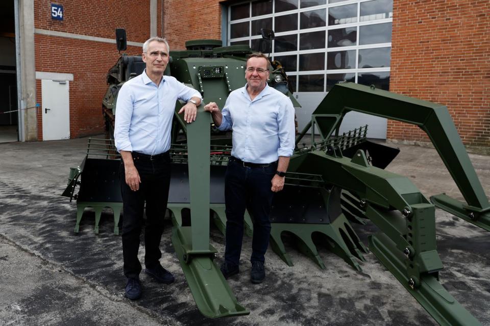 NATO Secretary General Jens Stoltenberg (L) and German Defence Minister Boris Pistorius pose for a photo with a mine clearance tank Wisent at FFG Flensburger Fahrzeugbau Gesellschaft on June 20, 2023 in Flensburg, Germany. FFG is a private company that is refurbishing Leopard 1 tanks that are being donated by NATO member countries to Ukraine. (Morris MacMatzen/Getty Images)