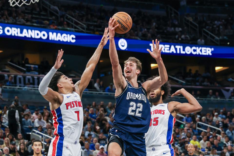 Orlando Magic forward Franz Wagner (22) goes to the basket against Detroit Pistons guard Killian Hayes (7) during the second quarter at Amway Center in Orlando, Florida on Friday, Dec. 8, 2023.