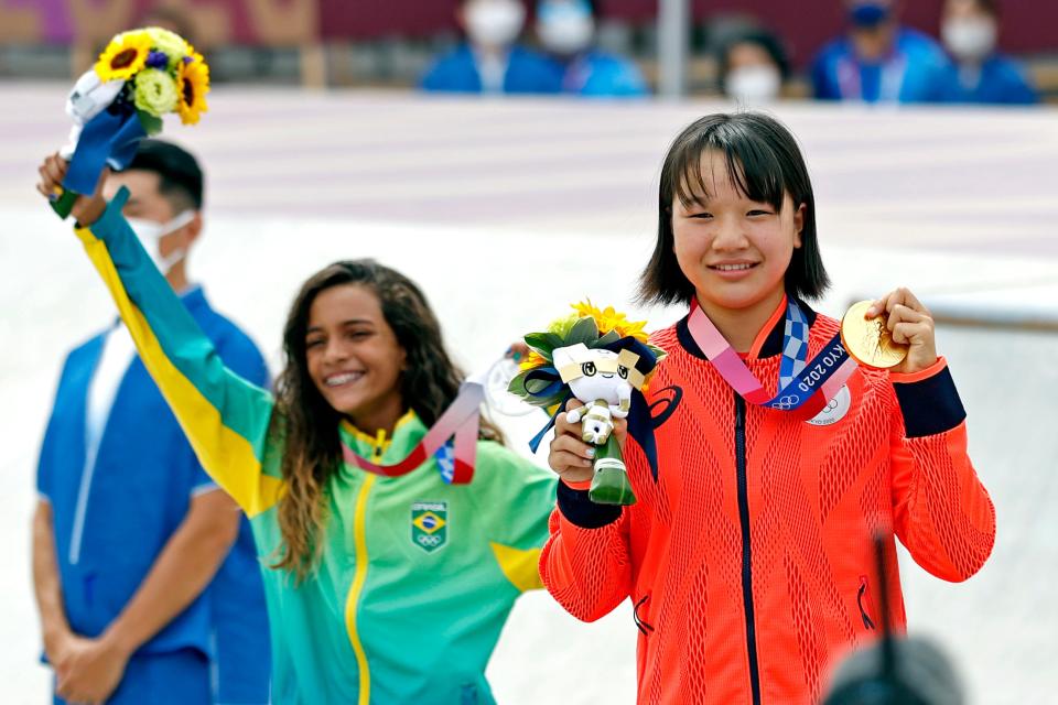 Momiji Nishiya (JPN) and Rayssa Leal (BRA) celebrate with their medals in the womens street skateboard during the Tokyo 2020 Olympic Summer Games at Ariake Urban Sports Park.