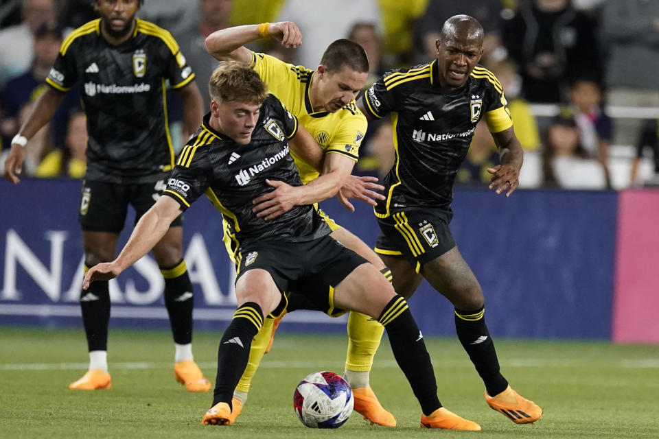 Columbus Crew midfielder Aidan Morris, front left, and Nashville SC midfielder Alex Muyl, front center, battle for the ball as Crew midfielder Darlington Nagbe, right, watches during the first half of an MLS soccer match Sunday, May 28, 2023, in Nashville, Tenn. (AP Photo/George Walker IV)