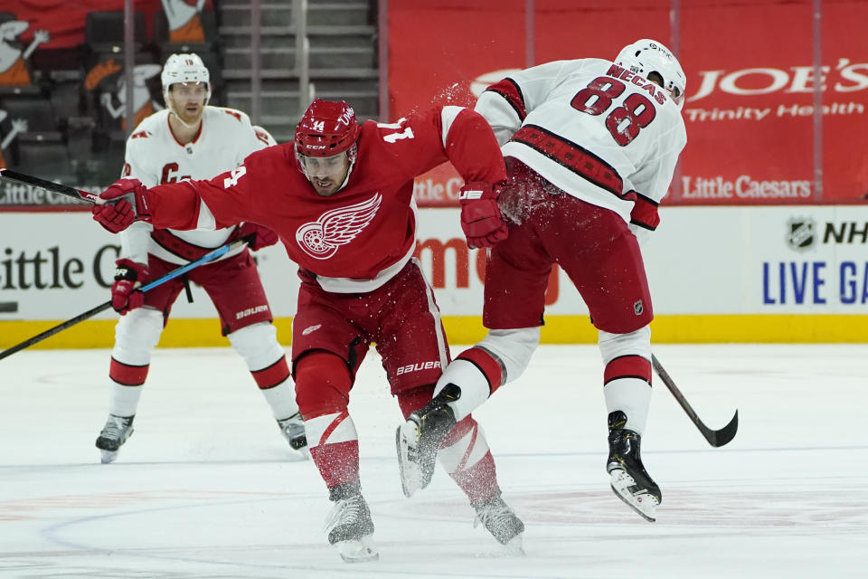 Detroit Red Wings center Robby Fabbri (14) and Carolina Hurricanes center Martin Necas (88) collide in the third period of an NHL hockey game Saturday, Jan. 16, 2021, in Detroit. (AP Photo/Paul Sancya)