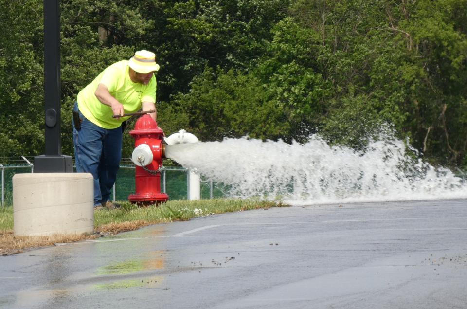 A hydrant outside the Bucyrus Water Treatment Plant is flushed in early May, part of installation of a new water line along Ohio 98 northeast of the city.