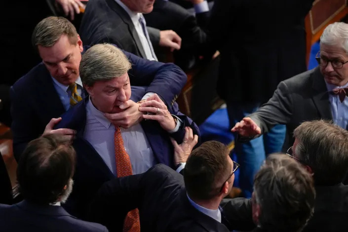 Rep. Richard Hudson, R-N.C., left, pulls Rep. Mike Rogers, R-Ala., back as they talk with Rep. Matt Gaetz, R-Fla., and other during the 14th round of voting for speaker as the House meets for the fourth day to try and elect a speaker and convene the 118th Congress in Washington, Friday, Jan. 6, 2023.