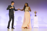 File-This July 12, 2015, file photo shows Wimbledon Champions Novak Djokovic of Serbia, left, and Serena Williams of the US, dancing on stage at the Wimbledon Champion dinner, at the Guildhall, London. Williams has been voted the AP Female Athlete of the Decade for 2010 to 2019. Williams won 12 of her professional-era record 23 Grand Slam singles titles over the past 10 years. No other woman won more than three in that span. She also tied a record for most consecutive weeks ranked No. 1 and collected a tour-leading 37 titles in all during the decade. Gymnast Simone Biles finished second in the vote by AP member sports editors and AP beat writers. Swimmer Katie Ledecky was third, followed by ski racers Lindsey Vonn and Mikaela Shiffrin. (Thomas Lovelock, Pool Photo via AP, File)