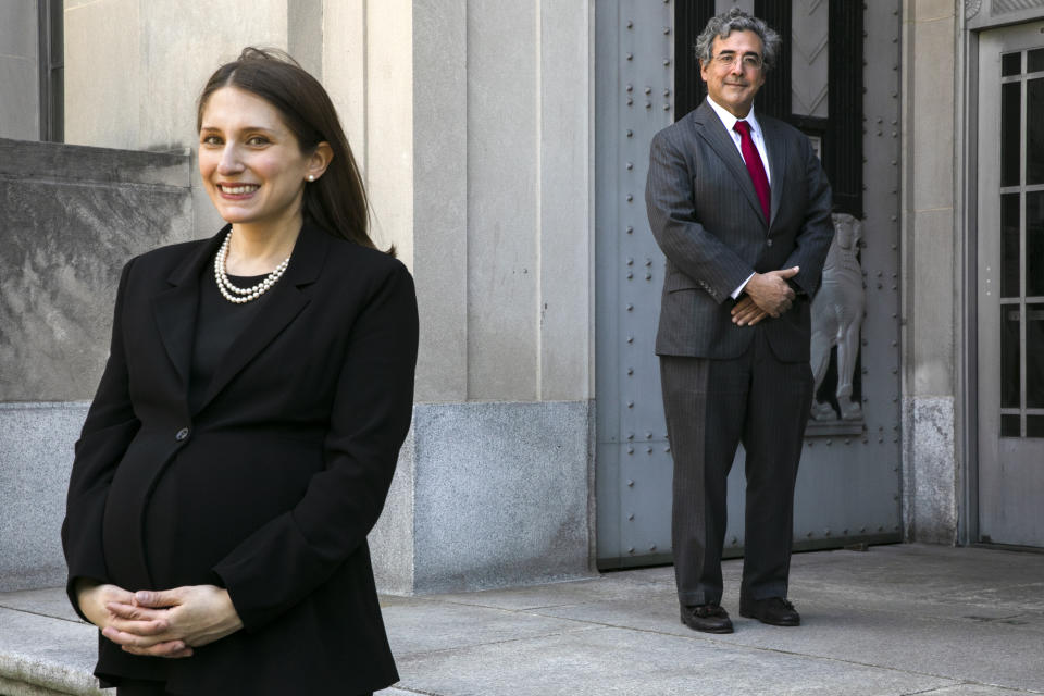 U.S. Solicitor General Noel Francisco, right, poses for a portrait with Attorney Erica Ross, left, Monday, May 4, 2020, from several feet away due to social distancing measures, outside the Department of Justice in Washington, after Ross became the first attorney to argue in the first arguments that the Supreme Court has argued via telephone. (AP Photo/Jacquelyn Martin)