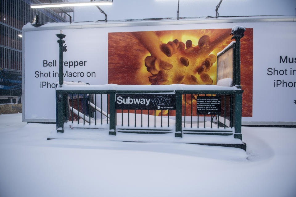 FILE - Snow covers the entrance to the subway station in the Bushwick section of the Brooklyn borough of New York, Jan. 29, 2022. Since the start of winter in December 2022, there has not been any measurable snowfall in New York City, meaning at least one-tenth of an inch accumulating on the ground, according to the National Weather Service. (AP Photo/Brittainy Newman, File)