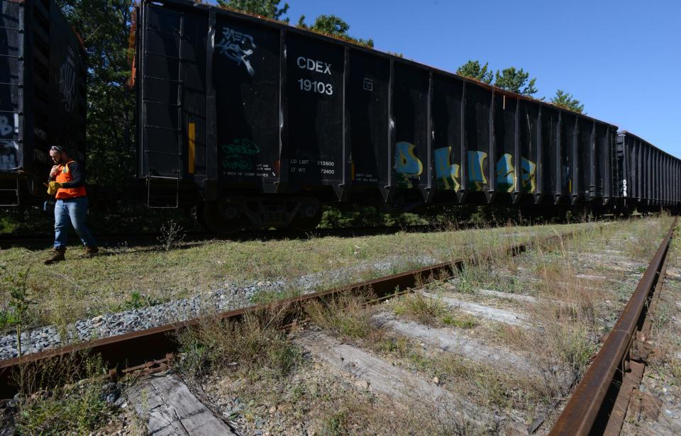 Massachusetts Coastal Railroad conductor Mike Valle inspects rail cars on Sept. 21 at the Upper Cape Regional Transfer Station at Joint Base Cape Cod.