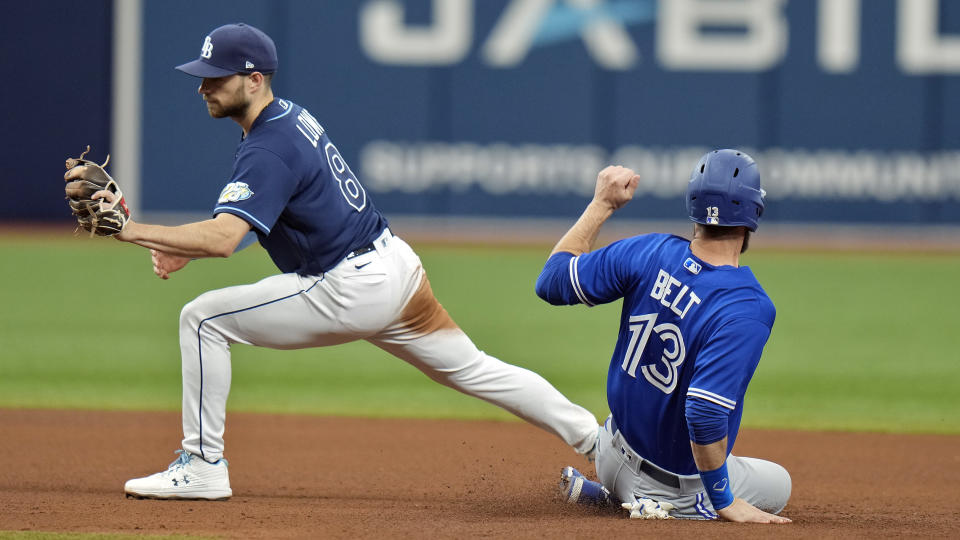 Tampa Bay Rays second baseman Brandon Lowe (8) forces Toronto Blue Jays' Brandon Belt (13) at second base on a fielder's choice by Matt Chapman during the fourth inning of a baseball game Thursday, May 25, 2023, in St. Petersburg, Fla. (AP Photo/Chris O'Meara)