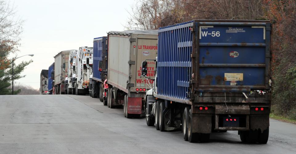 Trucks are lined up waiting to dump their loads at the Wheelabrator Westchester incineration plant in Peekskill Nov. 25, 2020.