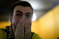 A fan reacts at a bar as he watches the World Cup 2022 qualifying play-off soccer match between Scotland and Ukraine in Kyiv, Ukraine, Wednesday, June 1, 2022. (AP Photo/Natacha Pisarenko)