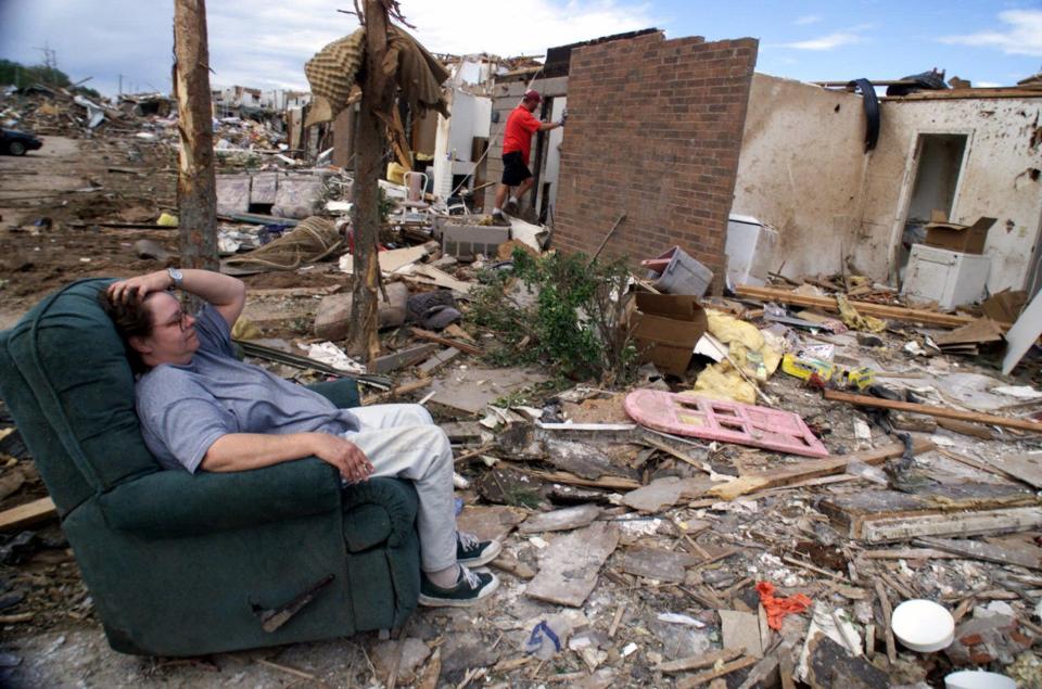 Vanessa Nelson, 44, sits in her recliner staring at what was once her first floor apartment at the Emerald Springs Apartment complex in southwest Oklahoma City, Okla., on Wednesday, May 5, 1999. (AP Photo/Beth A. Keiser)