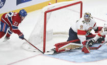 Montreal Canadiens' Cole Caufield (22) moves in to score on Florida Panthers goaltender Anthony Stolarz (41) during the third period of an NHL hockey game in Montreal, Tuesday, April 2, 2024. (Graham Hughes/The Canadian Press via AP)