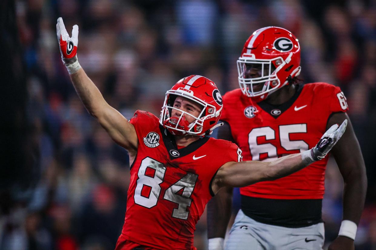 Nov 11, 2023; Athens, Georgia, USA; Georgia Bulldogs wide receiver Ladd McConkey (84) celebrates after a touchdown with offensive lineman Amarius Mims (65) against the Mississippi Rebels in the first quarter at Sanford Stadium.