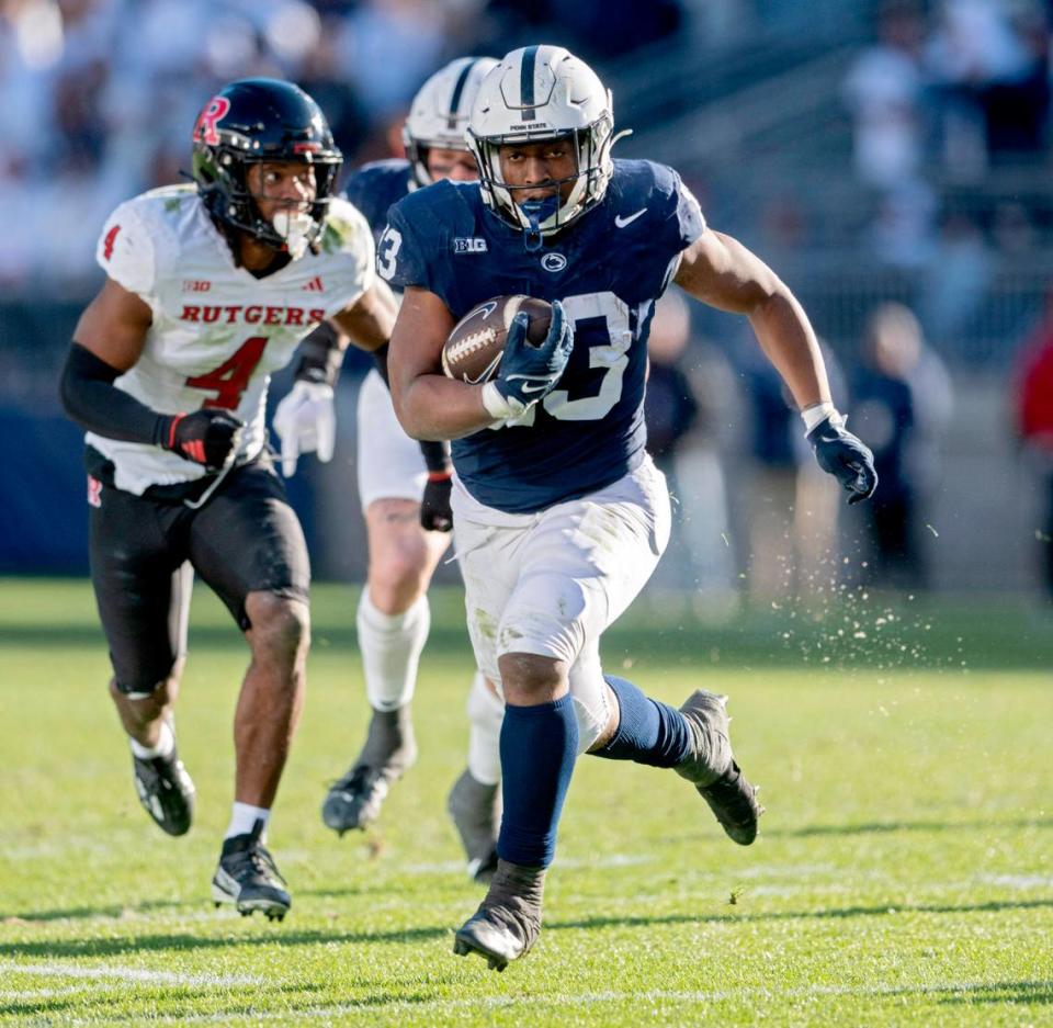 Penn State running back Kaytron Allen runs with the ball ahead of Rutgers defenders during the game on Saturday, Nov. 18, 2023.