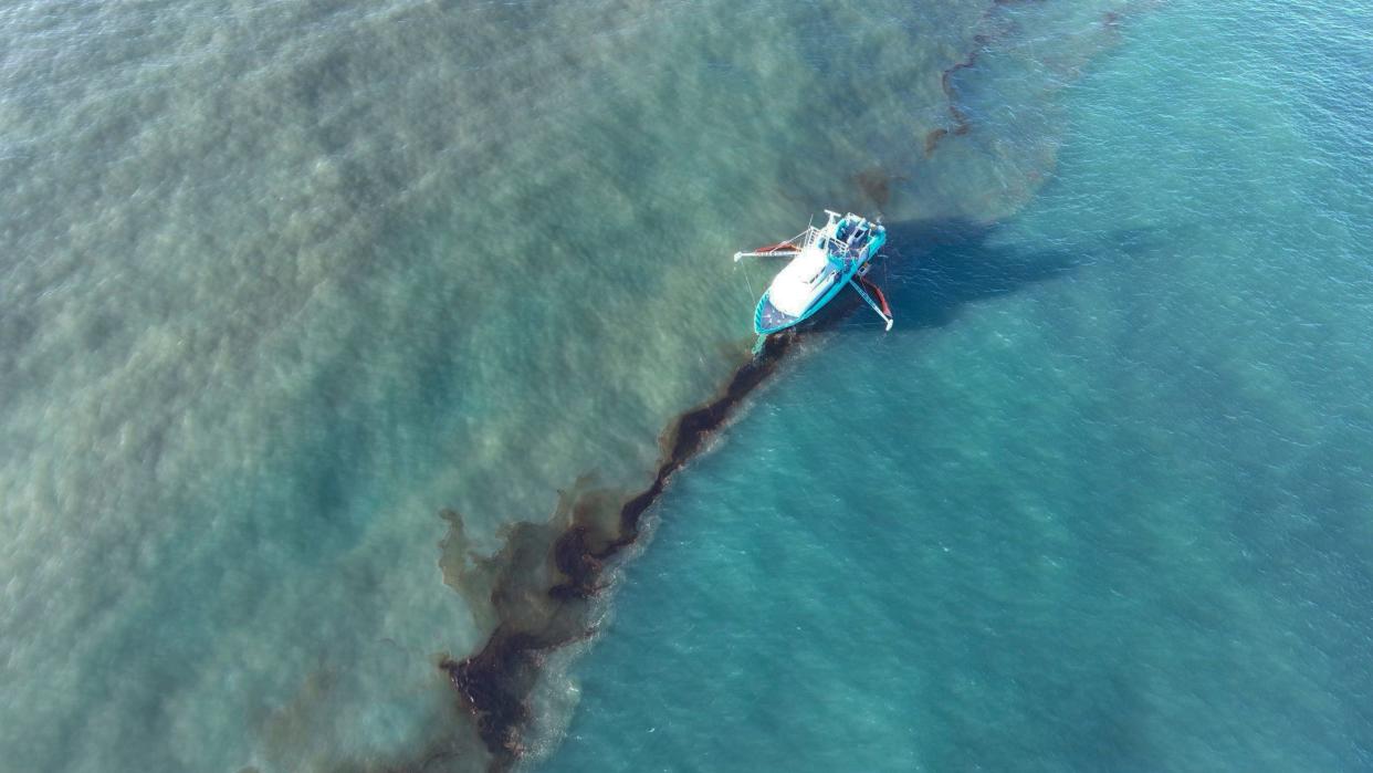 In this photo provided by the U.S. Coast Guard, a Clean Gulf Associates 95-foot response vessel skims crude oil on Friday, Nov. 17 approximately 4 miles southeast off South Pass Louisiana.