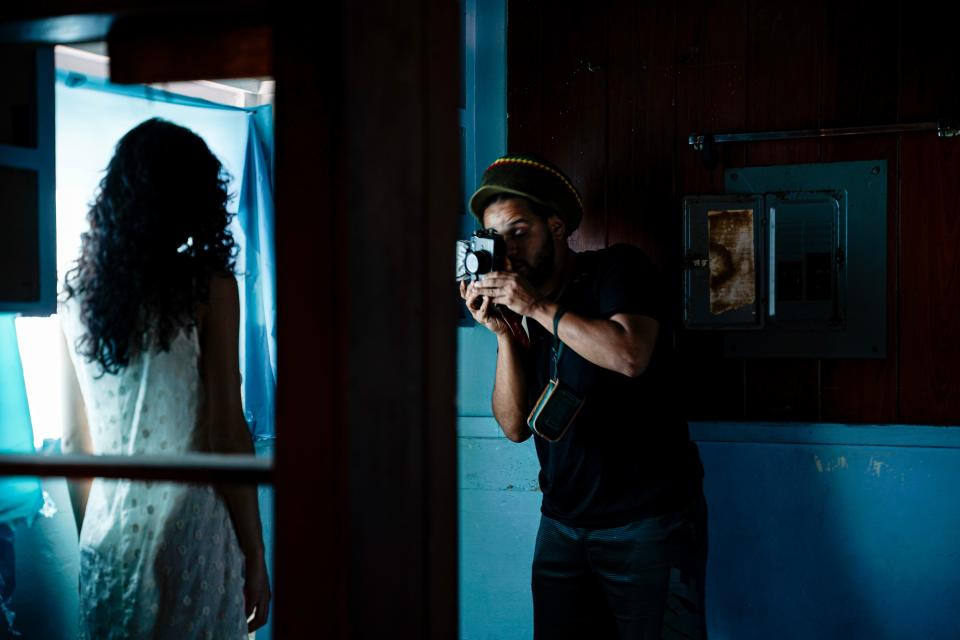 Jamiel Betancourt takes photos of a model during his photoshoot in Naples on Sunday, Feb. 19, 2023. 