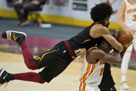 Cleveland Cavaliers' Jarrett Allen, top, fouls Atlanta Hawks' Clint Capela in the second half of an NBA basketball game, Tuesday, Feb. 23, 2021, in Cleveland. The Cavaliers won 112-111. (AP Photo/Tony Dejak)