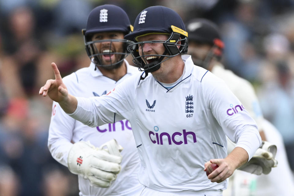 Ollie Pope of England celebrates after taking a close in catch to dismiss Daryl Mitchell of New Zealand on the second day of the second cricket test between England and New Zealand at the Basin Reserve in Wellington, New Zealand, Saturday, Feb. 25, 2023. (Andrew Cornaga/Photosport via AP)