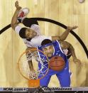 Kentucky's Willie Cauley-Stein and Louisville's Wayne Blackshear go after a rebound during the first half of an NCAA Midwest Regional semifinal college basketball tournament game Friday, March 28, 2014, in Indianapolis. (AP Photo/David J. Phillip)