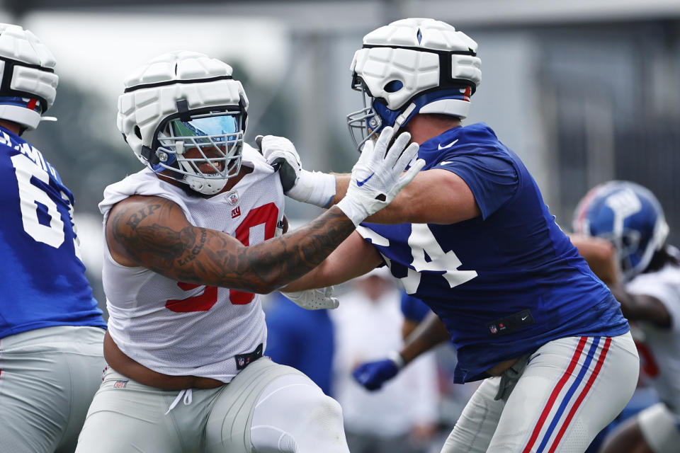 EAST RUTHERFORD, NEW JERSEY - JULY 27: Defensive end Leonard Williams #99 and guard Mark Glowinski #64 of the New York Giants during training camp at NY Giants Quest Diagnostics Training Center on July 27, 2023 in East Rutherford, New Jersey. (Photo by Rich Schultz/Getty Images)