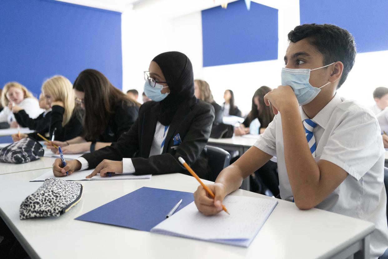 CARDIFF, WALES - SEPTEMBER 20: Children wear face masks during a maths lesson at Llanishen High School on September 20, 2021 in Cardiff, Wales. All children aged 12 to 15 across the UK will be offered a dose of the Pfizer-BioNTech Covid-19 vaccine. Parental consent will be sought for the schools-based vaccination programme. (Photo by Matthew Horwood/Getty Images)